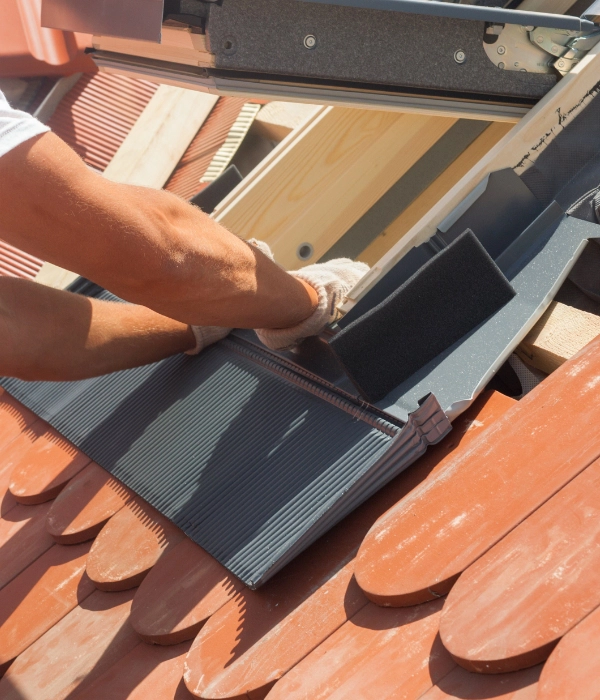 An employee from a roofing company in Inner Richmond installs a new roof.